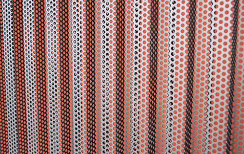 Farbige Fassadenbahn mit darüberliegendem gelochtem Aluminiumprofilblech; Aufstockung aus Holz